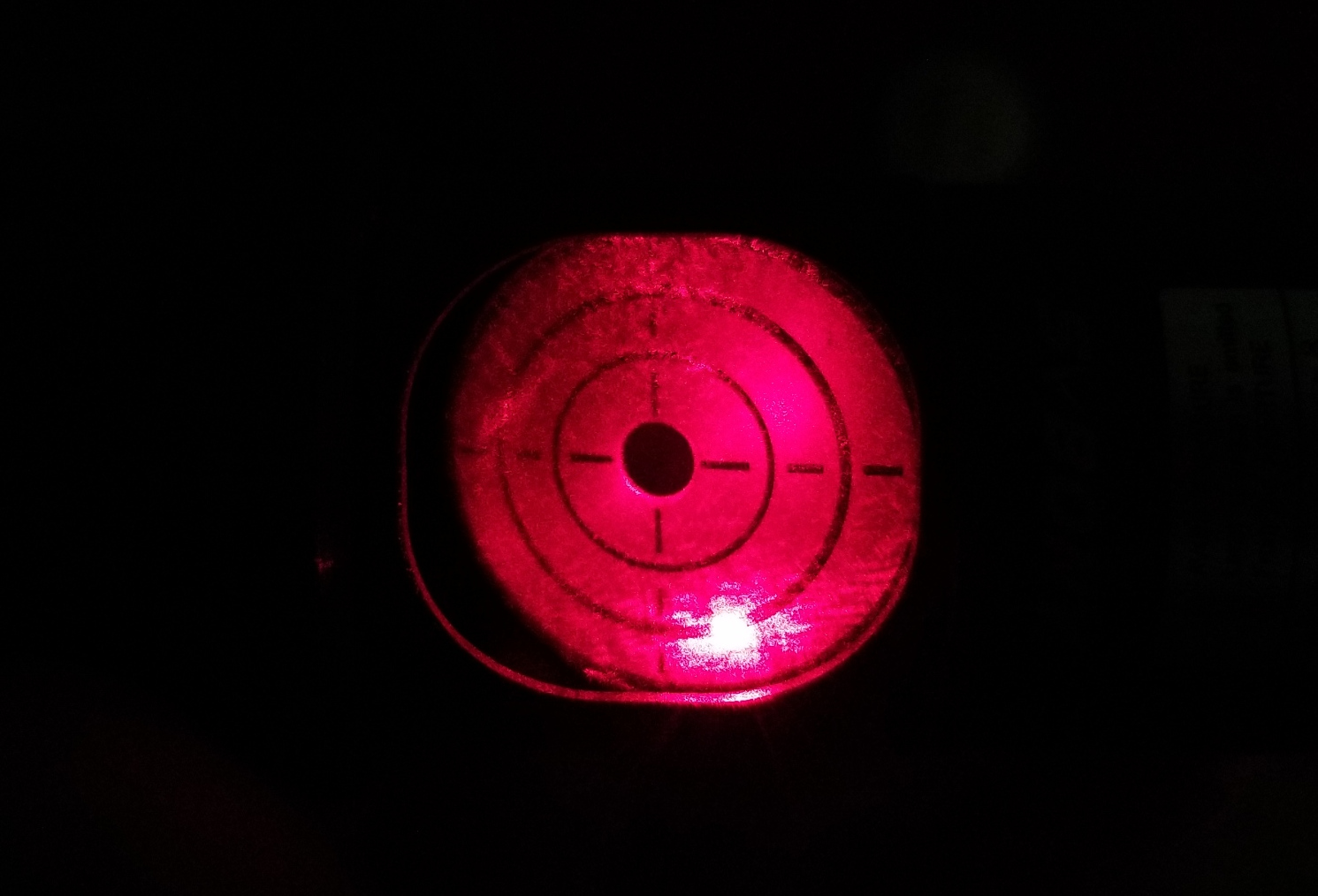 Laser dot appearing on collimator crosshair